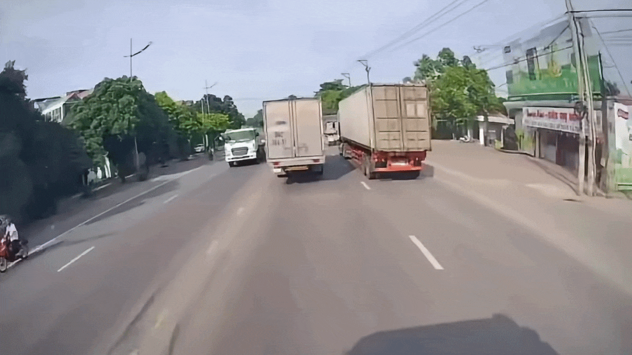 Clip: Tài xế xe máy liều mình lách vào giữa hai ô tô