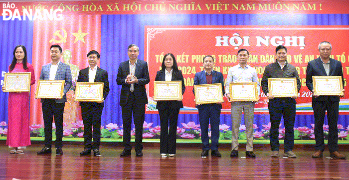 Chủ tịch UBND thành phố Lê Trung Chinh (thứ 4, bên trái sang) tặng bằng khen cho các tập thể và cá nhân có thành tích xuất sắc trong phong trào toàn dân bảo vệ an ninh Tổ quốc năm 2024. Ảnh: LÊ HÙNG